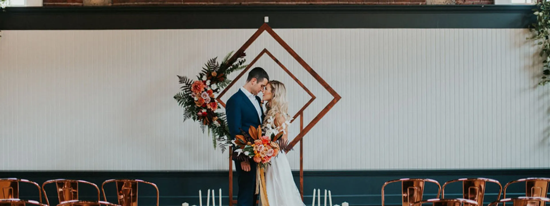 A geometric arch with tropical florals as a ceremony backdrop at The Evergreen in Portland